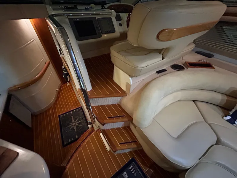 Slide: The Image of Interior of 2000 Sealine F44 yacht with beige leather seating and wooden flooring. - 16