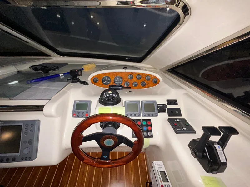 Slide: The Image of Cockpit of a 2000 Sealine F44 yacht with wooden steering wheel and navigation instruments. - 18