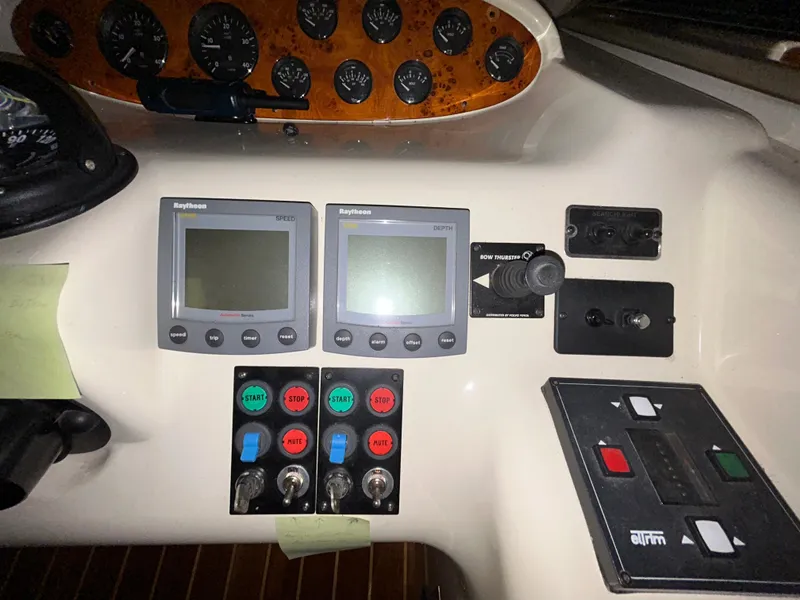 Slide: The Image of Control panel of a 2000 Sealine F44 boat with navigation instruments and switches. - 19