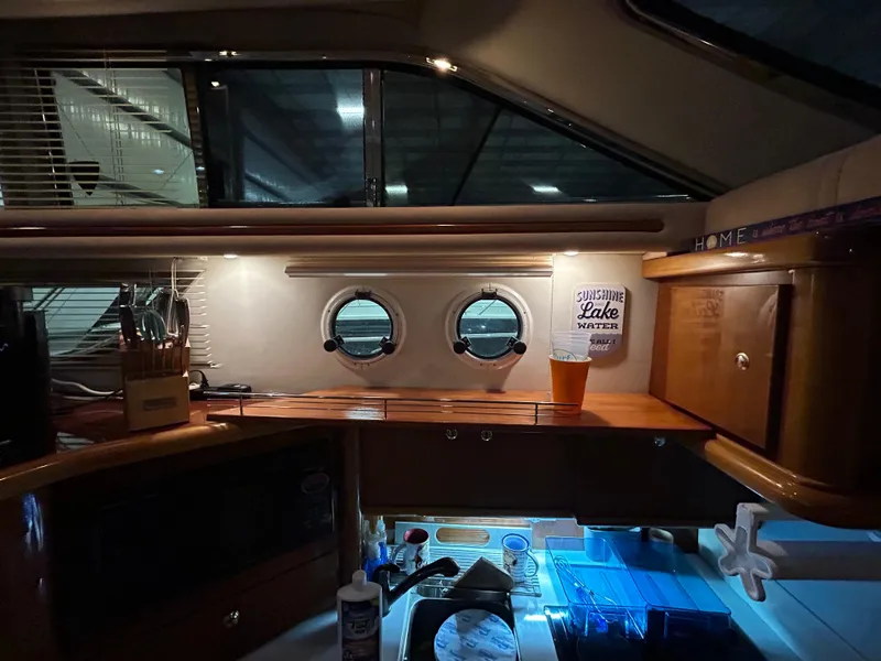 Slide: The Image of Interior of 2000 Sealine F44 yacht with portholes and wooden cabinetry. - 22