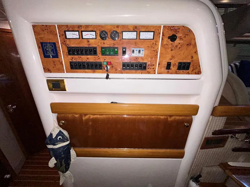 Slide: The Image of Control panel of a 2000 Sealine F44 yacht with wood accents and nautical decor. - 29