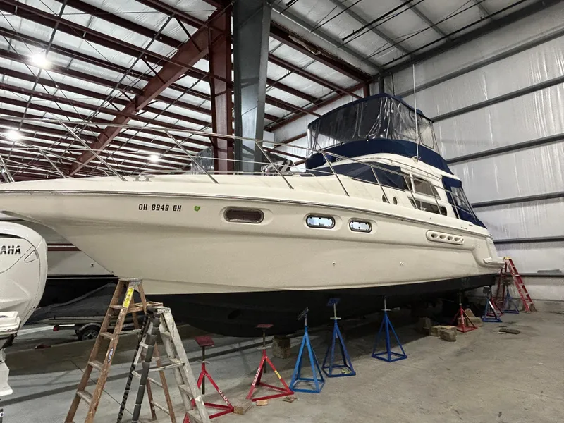 Slide: The Image of 2000 Sealine F44 yacht in storage, supported by stands in a warehouse. - 3