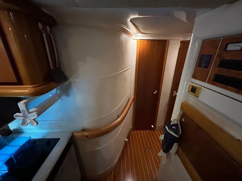 Slide: The Image of Interior of 2000 Sealine F44 yacht, featuring wooden flooring and modern cabinetry. - 31