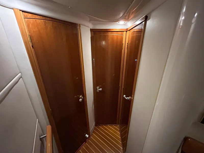 Slide: The Image of Hallway with wooden doors inside a 2000 Sealine F44 yacht. - 32