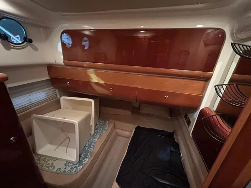 Slide: The Image of Interior cabin of 2000 Sealine F44 yacht with wooden cabinetry and porthole windows. - 33