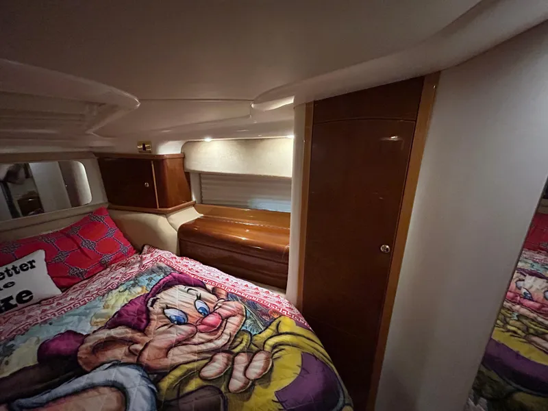 Slide: The Image of Cozy cabin interior of 2000 Sealine F44 yacht with colorful bedding and wooden accents. - 36