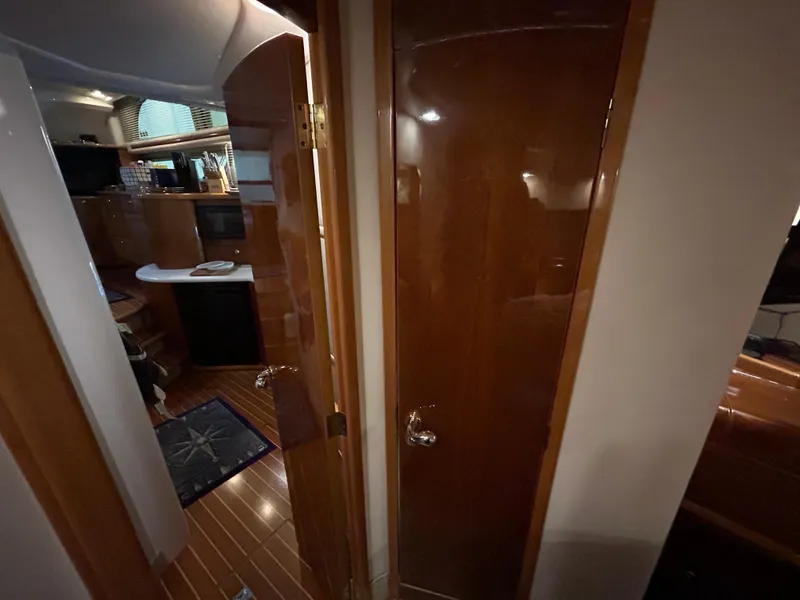 Slide: The Image of Interior of 2000 Sealine F44 yacht with polished wood finish and modern amenities. - 38