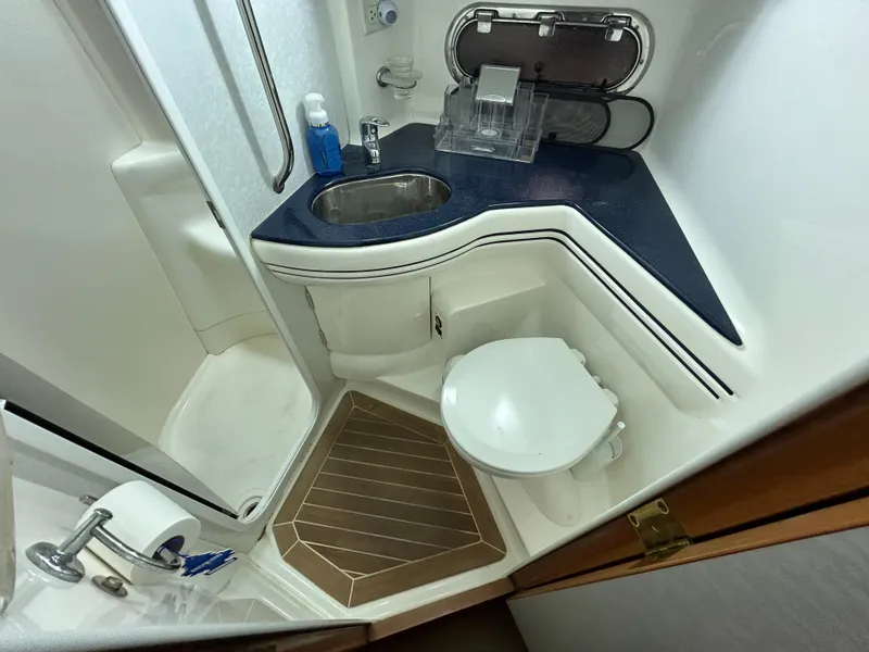 Slide: The Image of Sealine F44 2000 yacht bathroom with sink, toilet, and shower. - 40