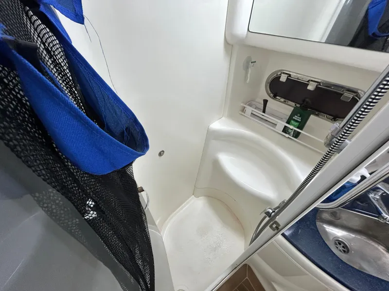 Slide: The Image of Sealine F44 2000 yacht bathroom with shower, sink, and storage shelves. - 41