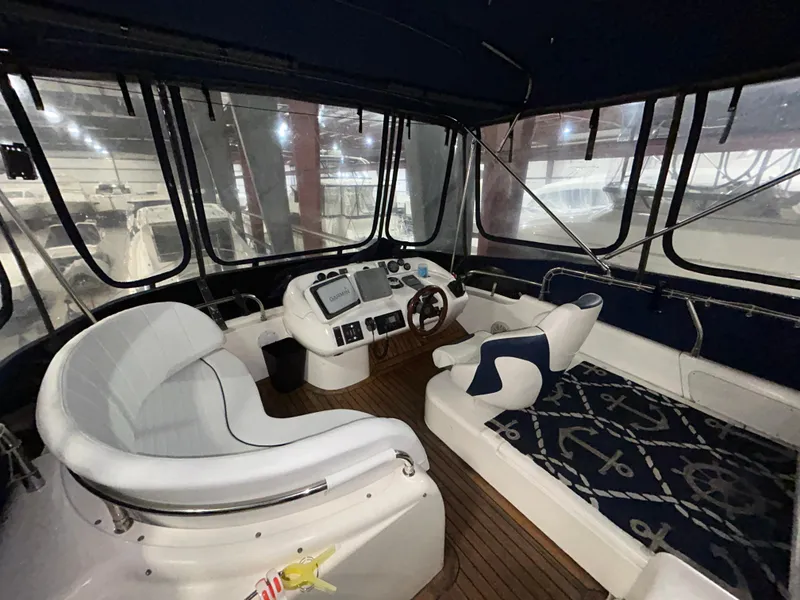 Slide: The Image of Interior view of 2000 Sealine F44 yacht cockpit with seating and navigation controls. - 44