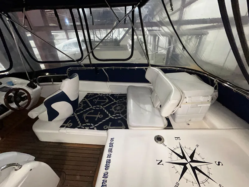 Slide: The Image of 2000 Sealine F44 yacht interior with compass design and cushioned seating. - 45