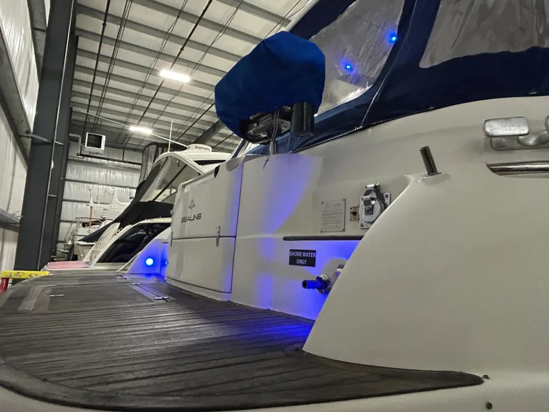 Slide: The Image of Sealine F44 yacht from 2000 in a storage facility with blue accent lighting. - 7
