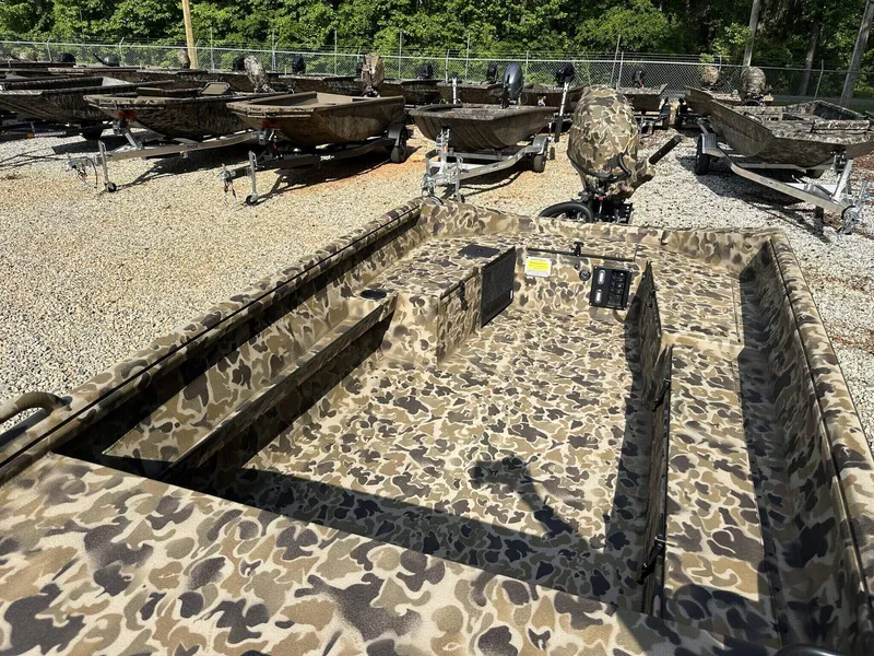 Slide: The Image of Camouflage-patterned 2025 Excel Viper F4 1751 boat in a gravel lot with trailers. - 4