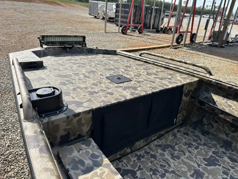 Slide: The Image of 2025 Excel Viper F4 1751 boat with camouflage design, parked on gravel. - 7