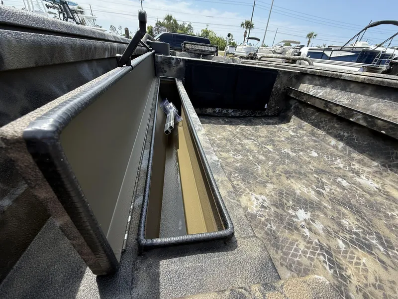 Slide: The Image of Open storage compartment on Excel Viper F4 1751-YAMHA 60 boat, 2025 model, with camouflage interior. - 10