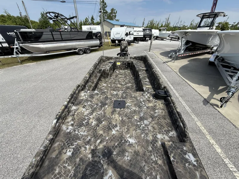 Slide: The Image of Camouflage-patterned Excel Viper F4 1751-YAMHA 60 boat, 2025 model, parked among other boats. - 6