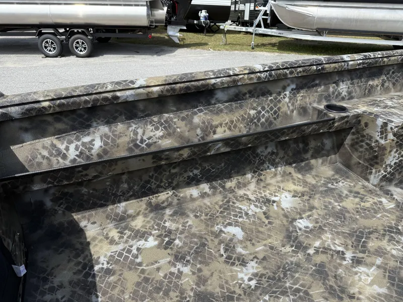 Slide: The Image of Camouflage interior of 2025 Excel Viper F4 1751-YAMHA 60 boat, with trailer in background. - 7