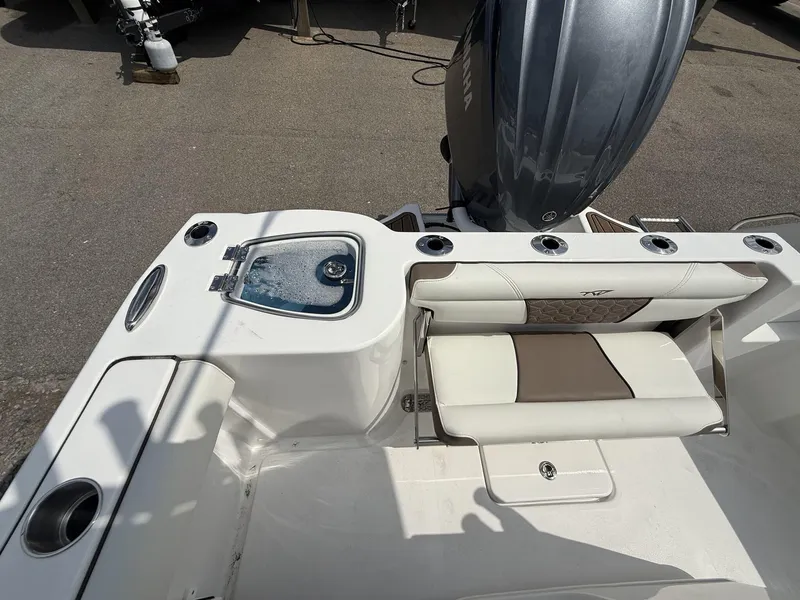 Slide: The Image of 2025 Tidewater 232 CC Adventure boat with Seakeeper Ride, featuring seating and engine view. - 10
