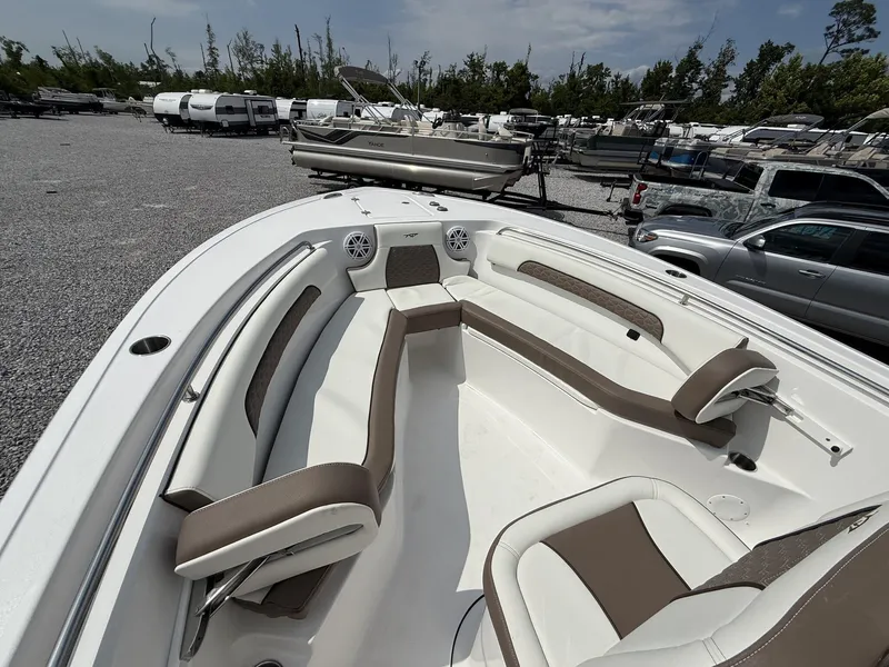 Slide: The Image of 2025 Tidewater 232 CC Adventure boat with spacious seating and modern design in a marina. - 15