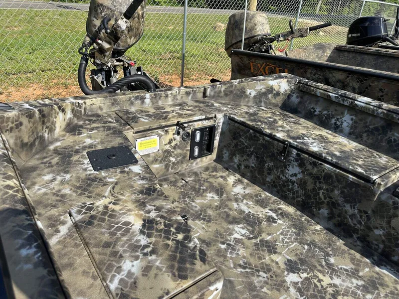 Slide: The Image of Camouflage-patterned interior of 2025 Excel Viper F4 1751 boat with motor and controls. - 7