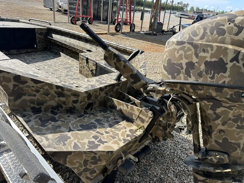 Slide: The Image of Camouflage-patterned Excel Viper F4 1751 boat, 2025 model, with outboard motor in a gravel lot. - 10