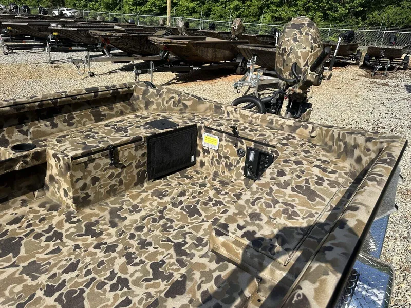 Slide: The Image of Camouflage-patterned Excel Viper F4 1751 boat, 2025 model, parked on gravel lot. - 5