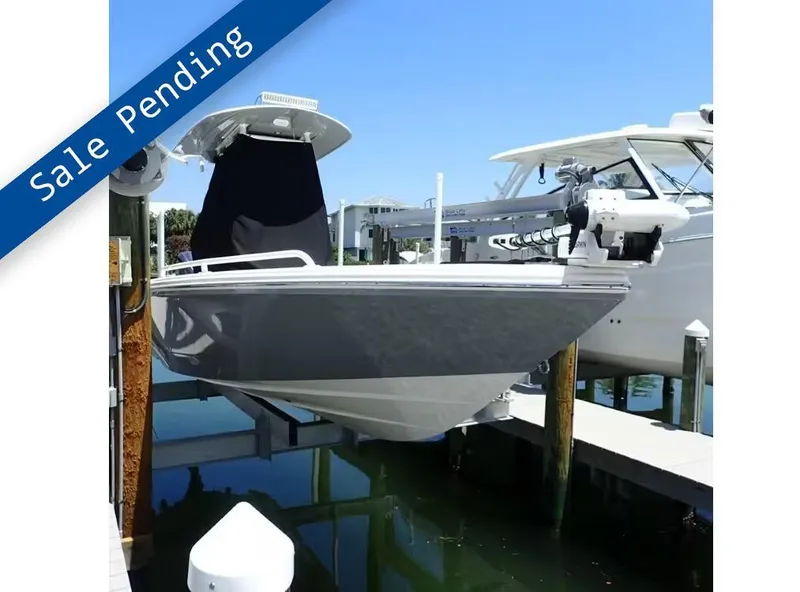 Slide: The Image of 2024 Pathfinder 2600 TRS boat with "Sale Pending" banner, docked in marina. - 1