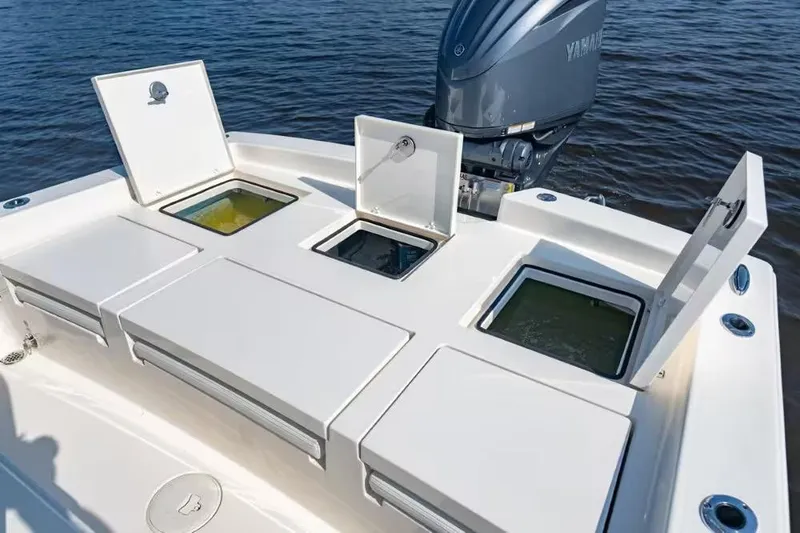 Slide: The Image of 2024 Pathfinder 2600 TRS boat with open storage compartments and Yamaha engine on water. - 12