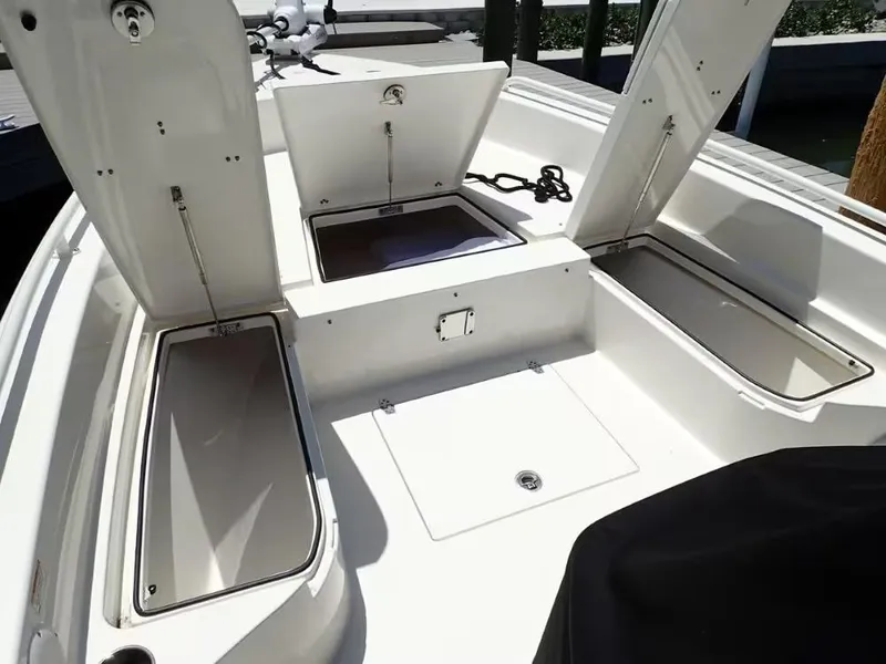 Slide: The Image of 2024 Pathfinder 2600 TRS boat storage compartments open on deck. - 17