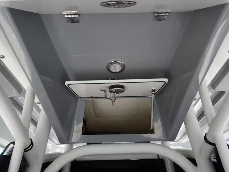 Slide: The Image of 2024 Pathfinder 2600 TRS boat interior detail with storage compartment and metal fixtures. - 19