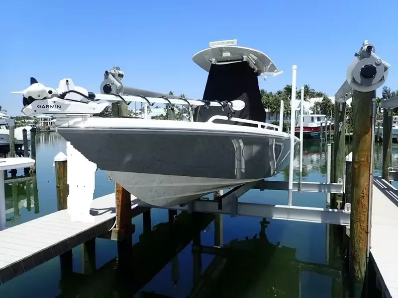 Slide: The Image of 2024 Pathfinder 2600 TRS boat on lift, equipped with Garmin technology, docked in marina. - 2