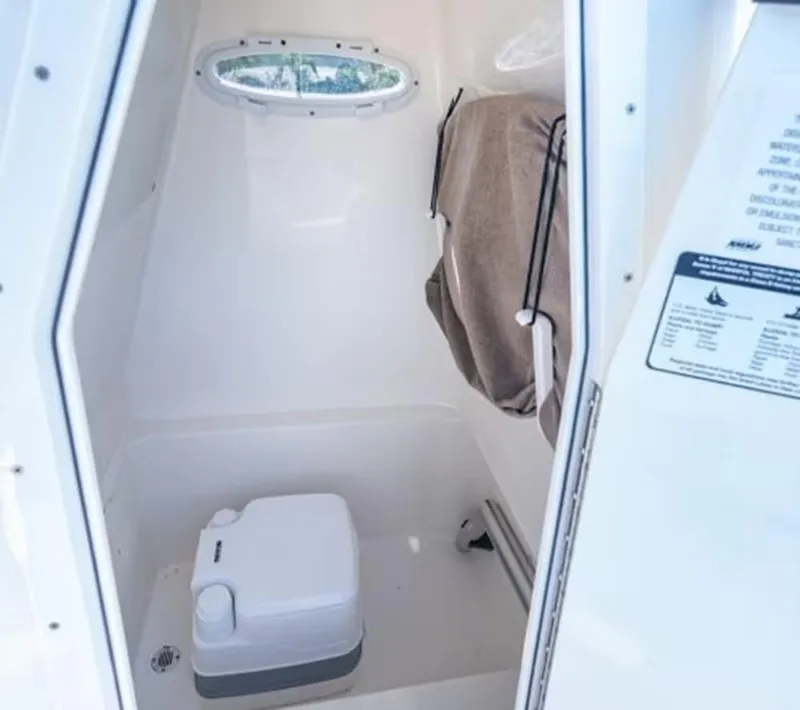 Slide: The Image of 2024 Pathfinder 2600 TRS boat interior with compact toilet and window. - 21