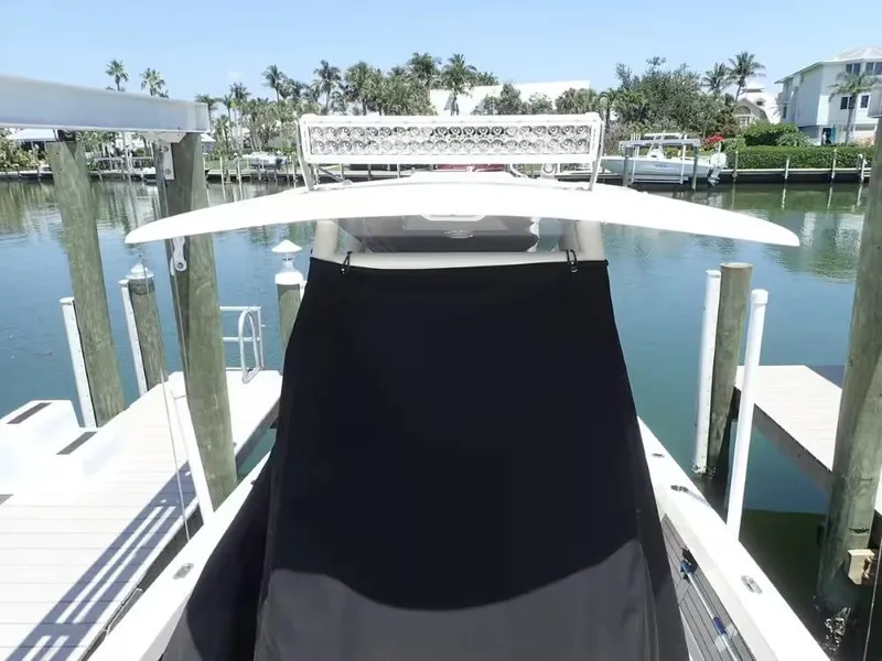 Slide: The Image of 2024 Pathfinder 2600 TRS boat docked in a serene marina setting. - 22