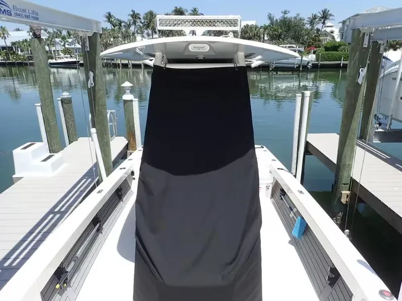 Slide: The Image of 2024 Pathfinder 2600 TRS boat docked at marina with covered console. - 23