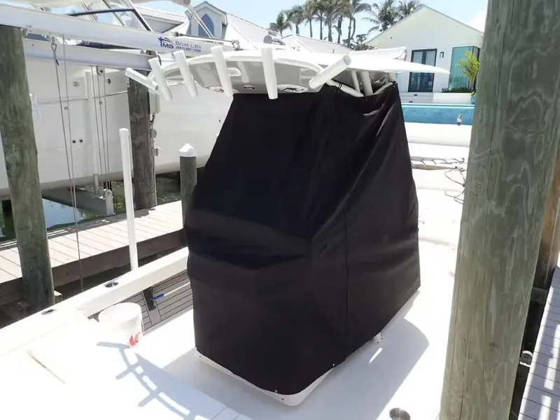 Slide: The Image of 2024 Pathfinder 2600 TRS boat console covered with black fabric at a dock. - 24