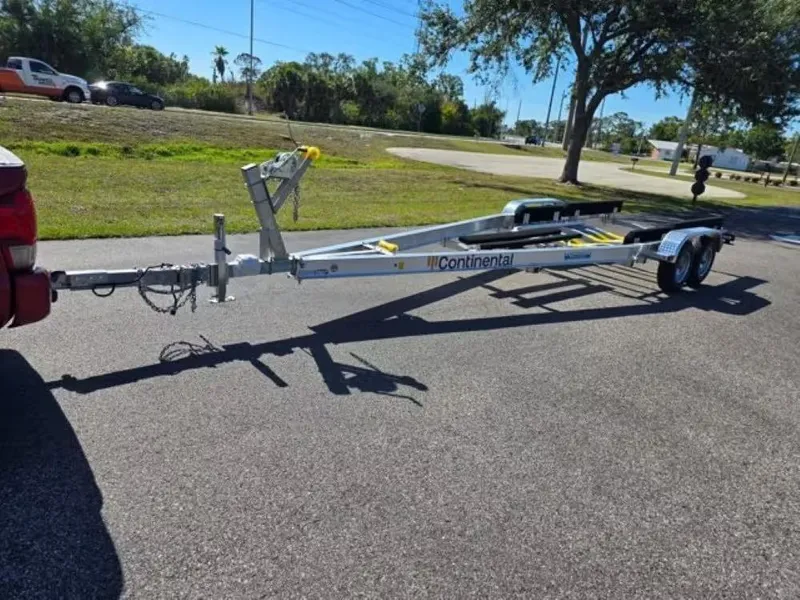Slide: The Image of Trailer hitched to a vehicle on a sunny road, ready for transport. - 25