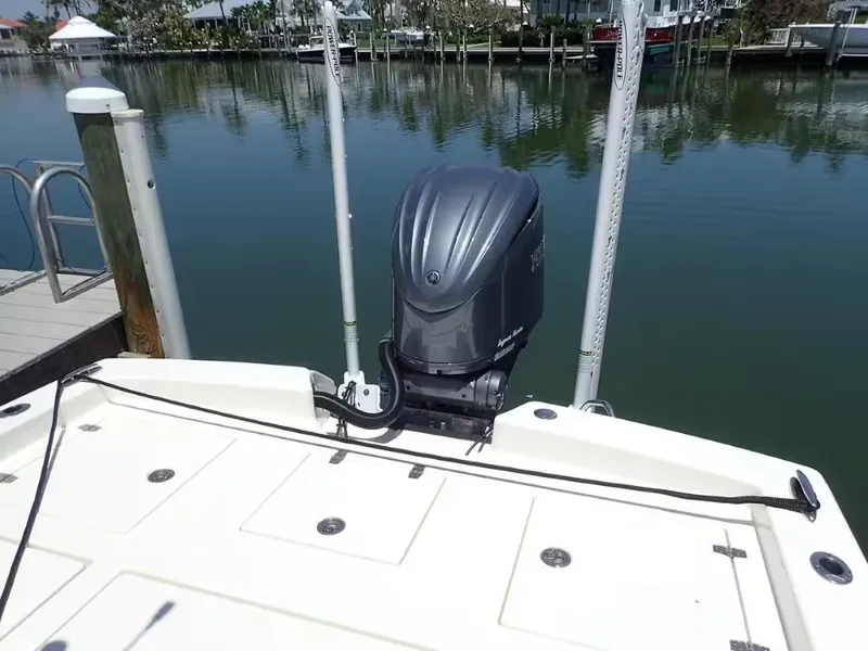 Slide: The Image of 2024 Pathfinder 2600 TRS boat with outboard motor docked by calm waters. - 3