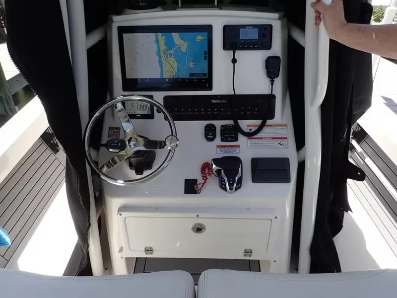 Slide: The Image of 2024 Pathfinder 2600 TRS boat console with steering wheel, navigation screen, and controls. - 6