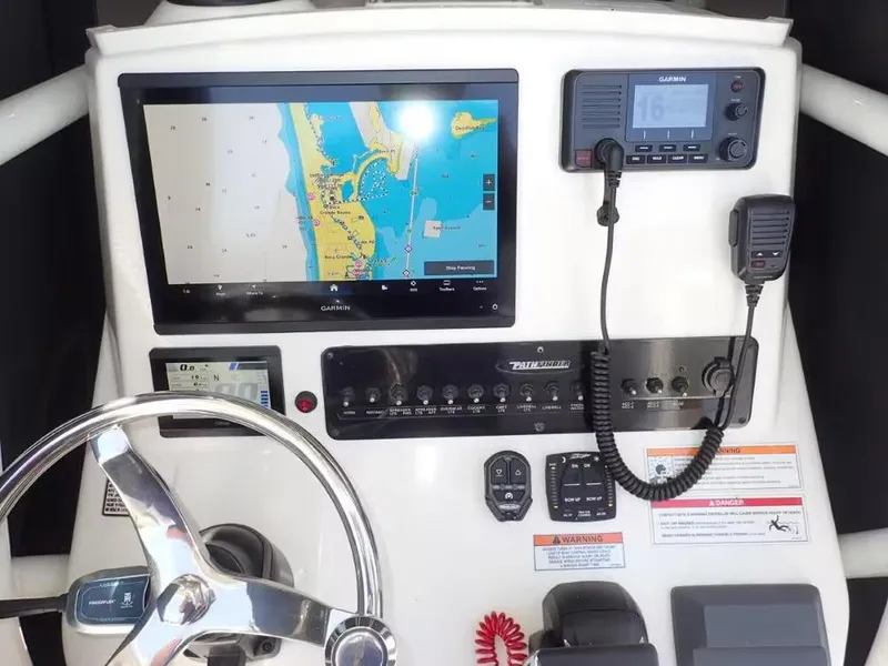 Slide: The Image of 2024 Pathfinder 2600 TRS boat dashboard with Garmin navigation and communication equipment. - 7