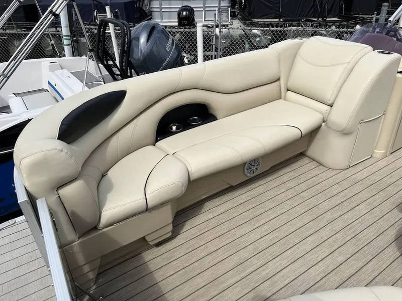 Slide: The Image of Luxurious seating on 2018 Sylvan Mirage 8522 Cruise Port boat, featuring beige upholstery and cup holders. - 11