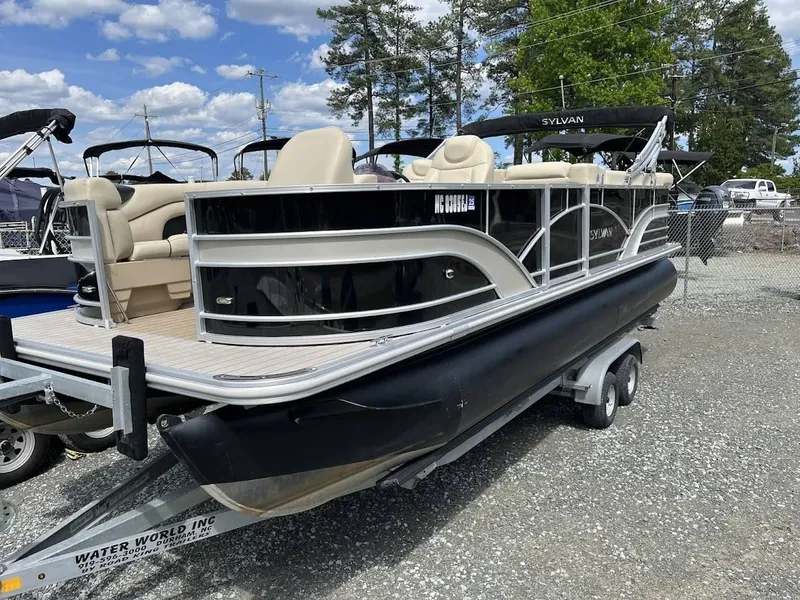 Slide: The Image of 2018 Sylvan Mirage 8522 Cruise Port pontoon boat on trailer, parked outdoors. - 2
