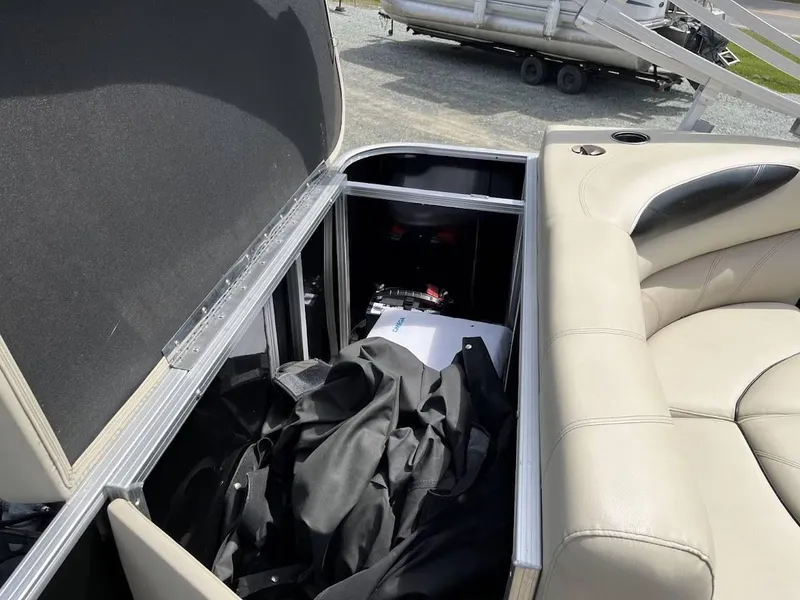 Slide: The Image of Open storage compartment in 2018 Sylvan Mirage 8522 Cruise Port boat with beige seating. - 5