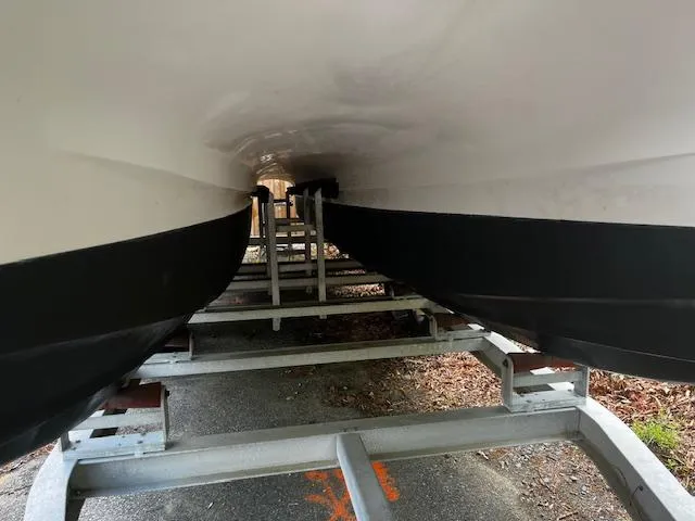 Slide: The Image of Underneath view of a 1997 Grady-White F-26 Tigercat boat on a trailer. - 10