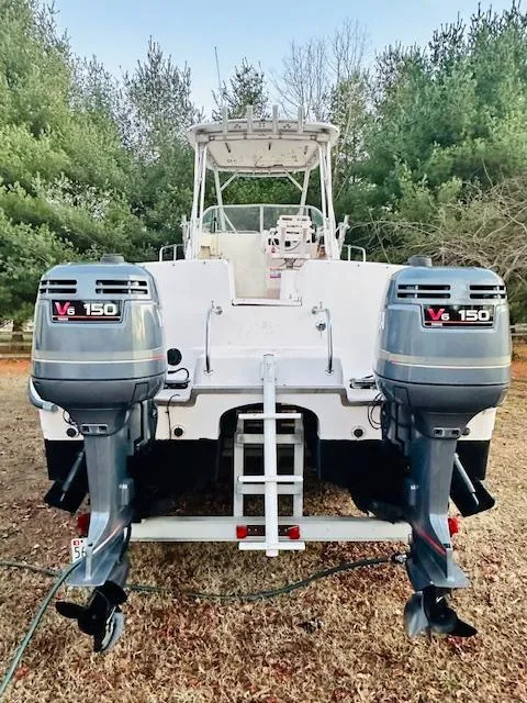 Slide: The Image of 1997 Grady-White F-26 Tigercat boat with dual V6 150 engines, parked on grass. - 13