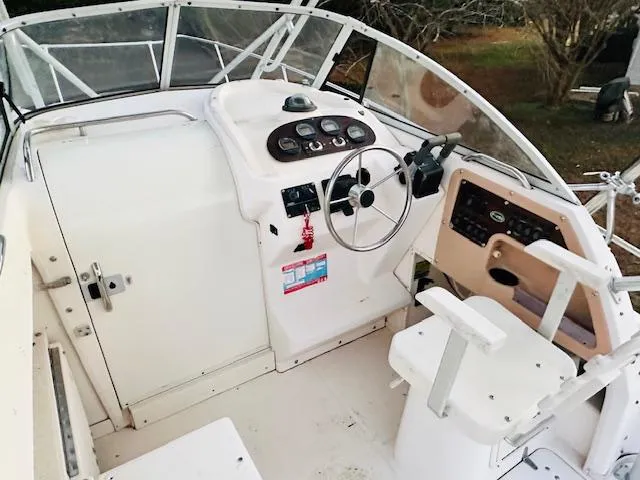 Slide: The Image of 1997 Grady-White F-26 Tigercat boat cockpit with steering wheel and control panel. - 5