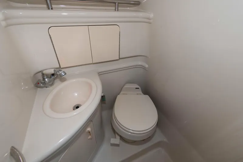Slide: The Image of 2007 Sea Ray 280 Sundancer bathroom with sink and toilet, compact marine design. - 11