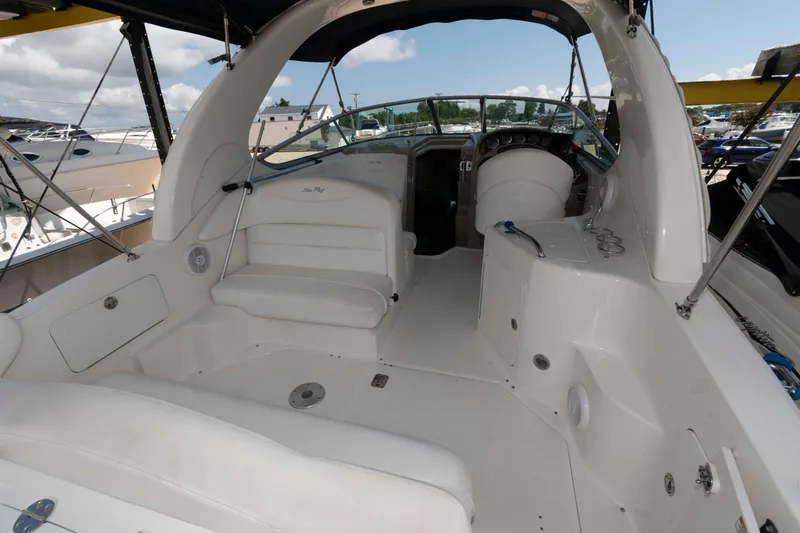 Slide: The Image of 2007 Sea Ray 280 Sundancer boat interior with white seating and dashboard. - 2