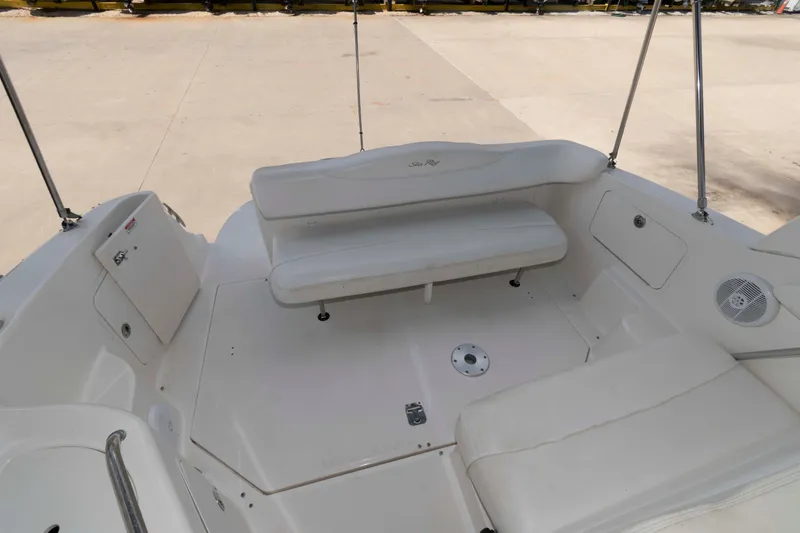 Slide: The Image of 2007 Sea Ray 280 Sundancer boat interior with white seating and storage compartments. - 3