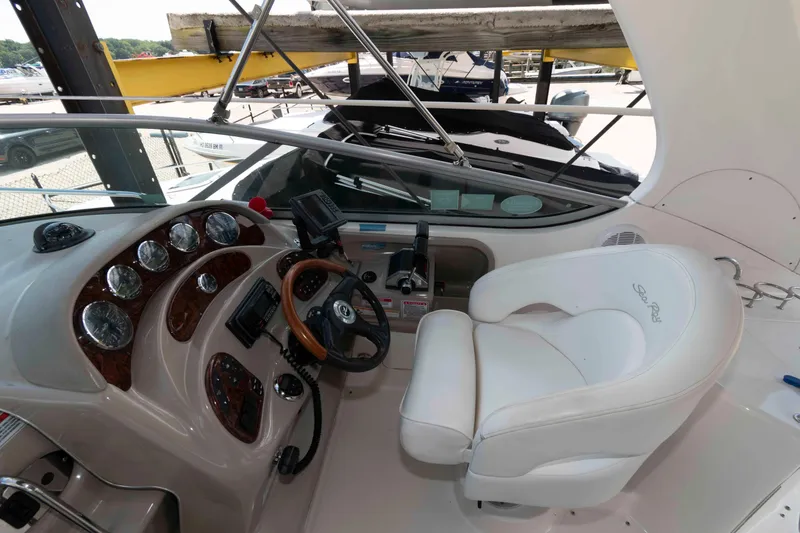 Slide: The Image of 2007 Sea Ray 280 Sundancer helm with white captain's chair and wooden steering wheel. - 5