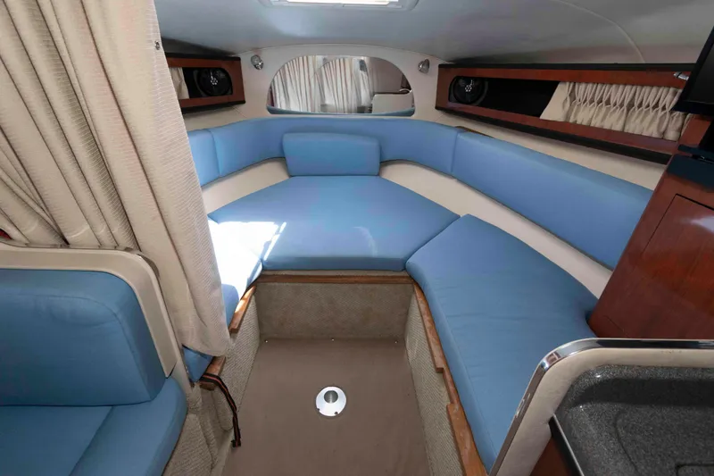 Slide: The Image of 2007 Sea Ray 280 Sundancer interior with blue seating and wood accents. - 9